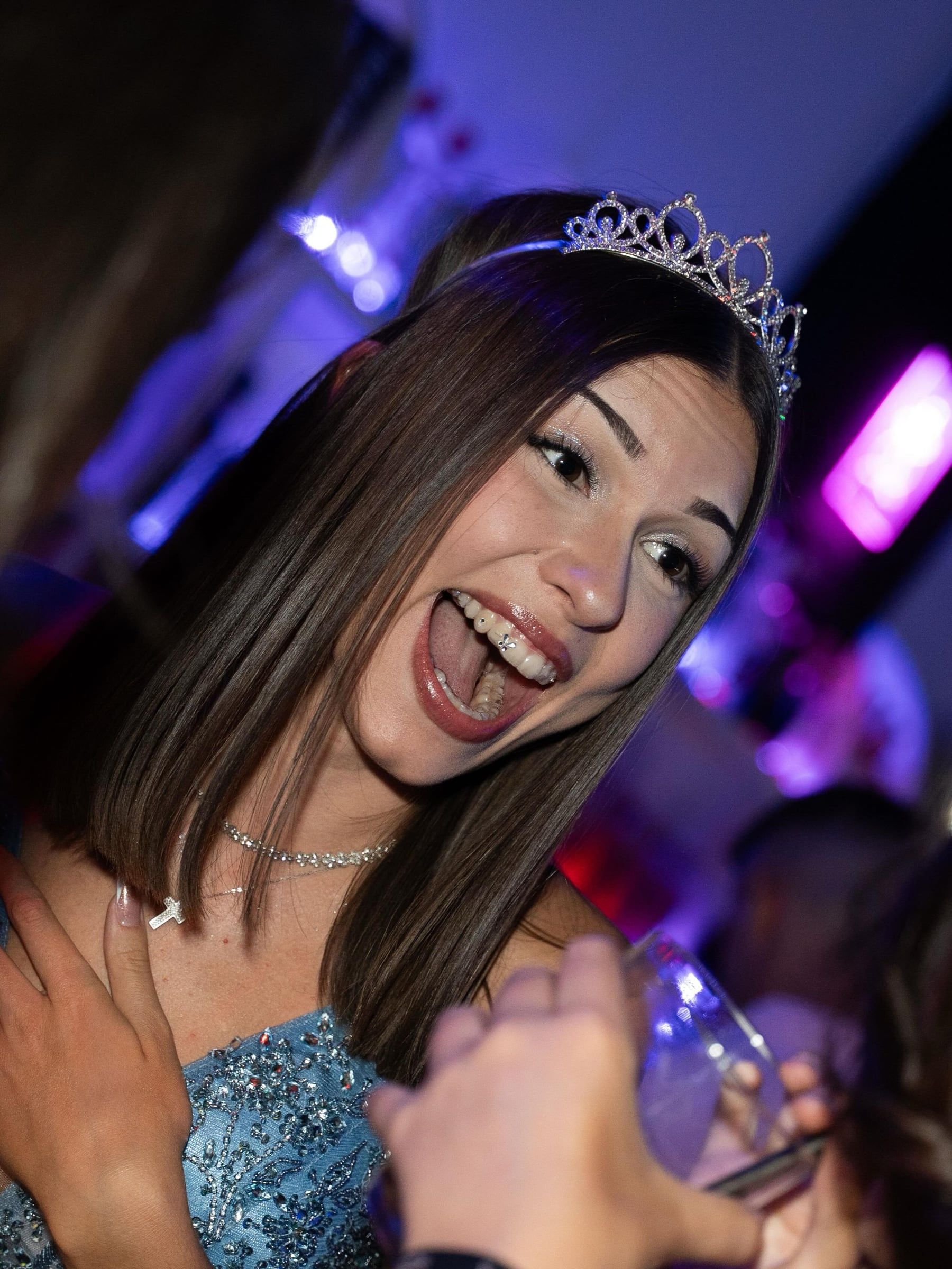 Cumpleañera con tiara riendo a carcajadas
